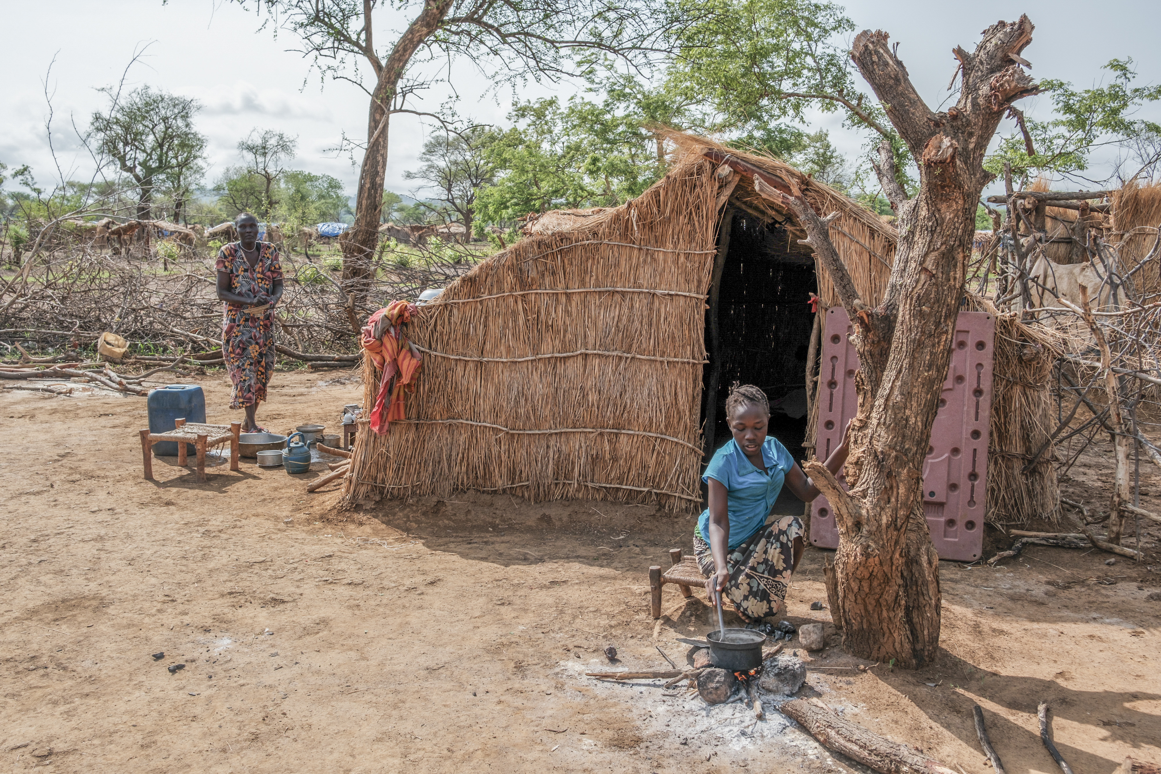 A person cooking leaves from nearby trees.