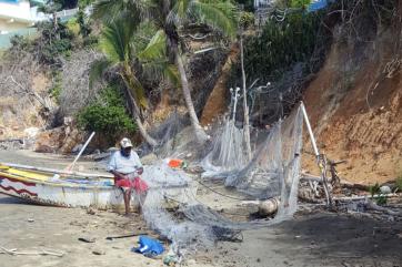 Fisherman with boat and supplies