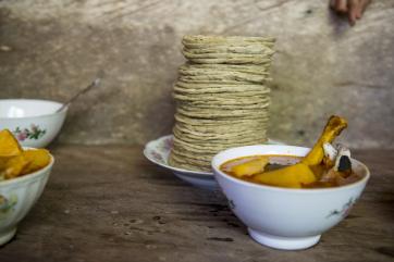 Bowls of soup and a stack of tortillas on a table in guatemala