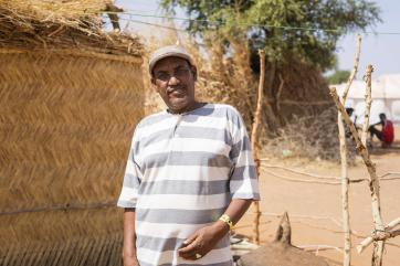 A person standing outside their home.