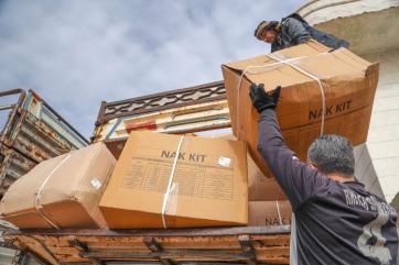 People unloading emergency kits.