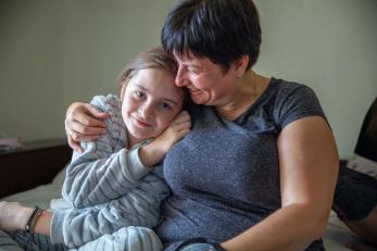 A mother embraces her daughter in ukraine