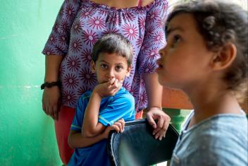 Anibal looks on as his mother, Paola, receives cash and a water filter provided by Mercy Corps. After the storm, many families have resorted to drinking from rivers, streams or pipes, making them vulnerable to serious contamination and illness. “I’m planning on buying things for the kids that we lost, like clothes and shoes, as well as food and water,” Paola says. “I want my kids to go to school to do good and go as far as they can go.”