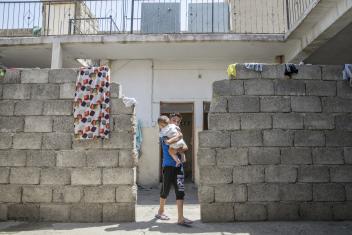 Mustafa, 9, carries his 6-month-old cousin, Rayan, near the home they share with their grandmother and five other families. A cash distribution from Mercy Corps helps the family meet their urgent needs after their house and car were destroyed in the conflict. ALL PHOTOS: Ezra Millstein