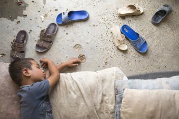 Abdulrahman sleeps on the floor inside his family's tent at the Jeddah displacement camp. His family fled the fighting in Mosul nine months ago. For three days they traveled at night through the desert with nothing but the clothes they were wearing. A household kit from Mercy Corps provided them a kitchen set, six blankets, two jerrycans, a tarp and a rope.