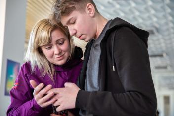 With her two sons, Alla Mabruseva arrived at a shelter in Lviv, Ukraine. The shelter used to be a cultural center and is supported by Mercy Corps. She fled Mariupol and is reading a message on her phone with news that her parents are still alive in her hometown. “If it wasn't for help centers like this one, no one would be able to get out,” said Alla.